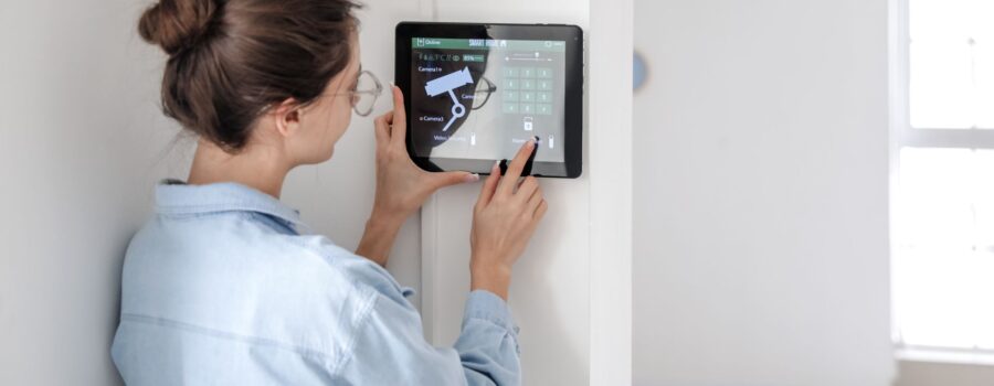 A woman using a wall-mounted table for home security