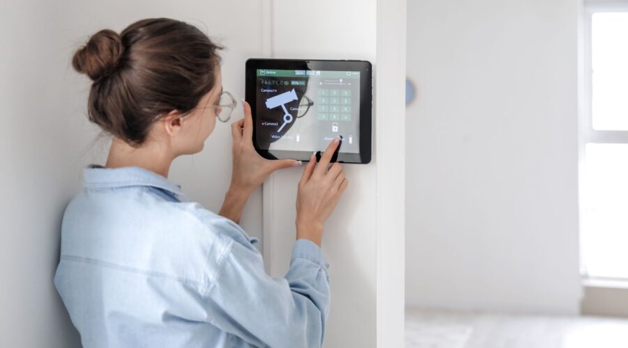 A woman using a wall-mounted table for home security