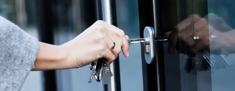 woman unlocking business door