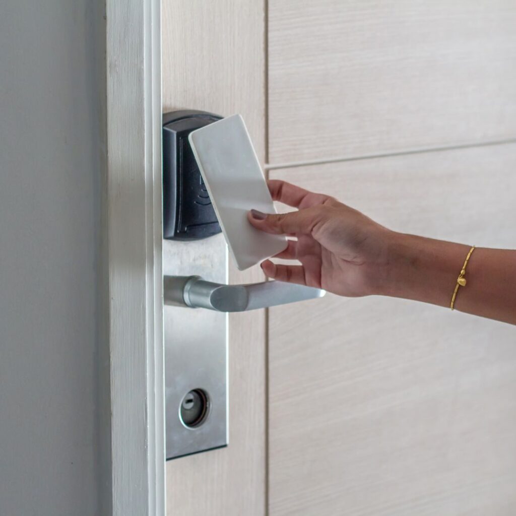 Person holding access card to electronic door lock