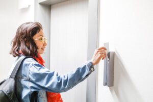 Person swiping an access card at a door