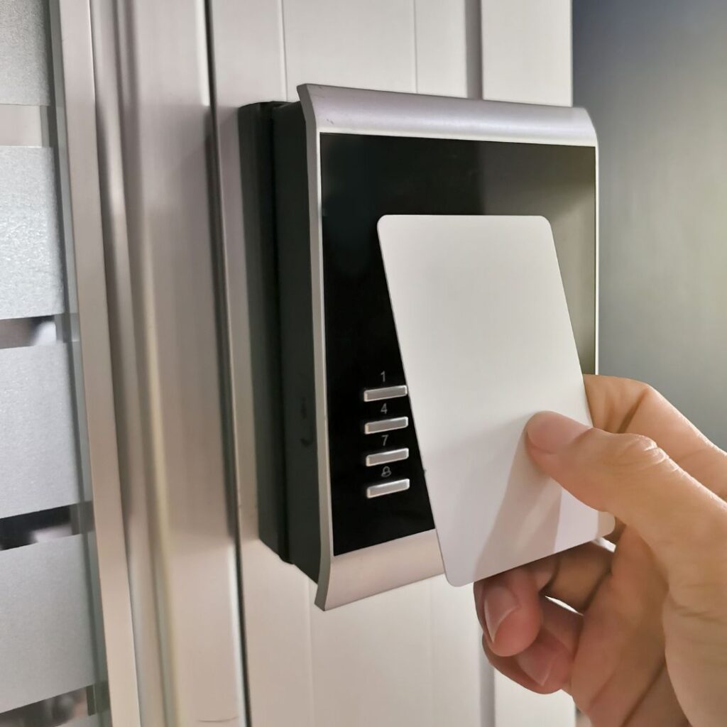 a person using a key card on a security panel